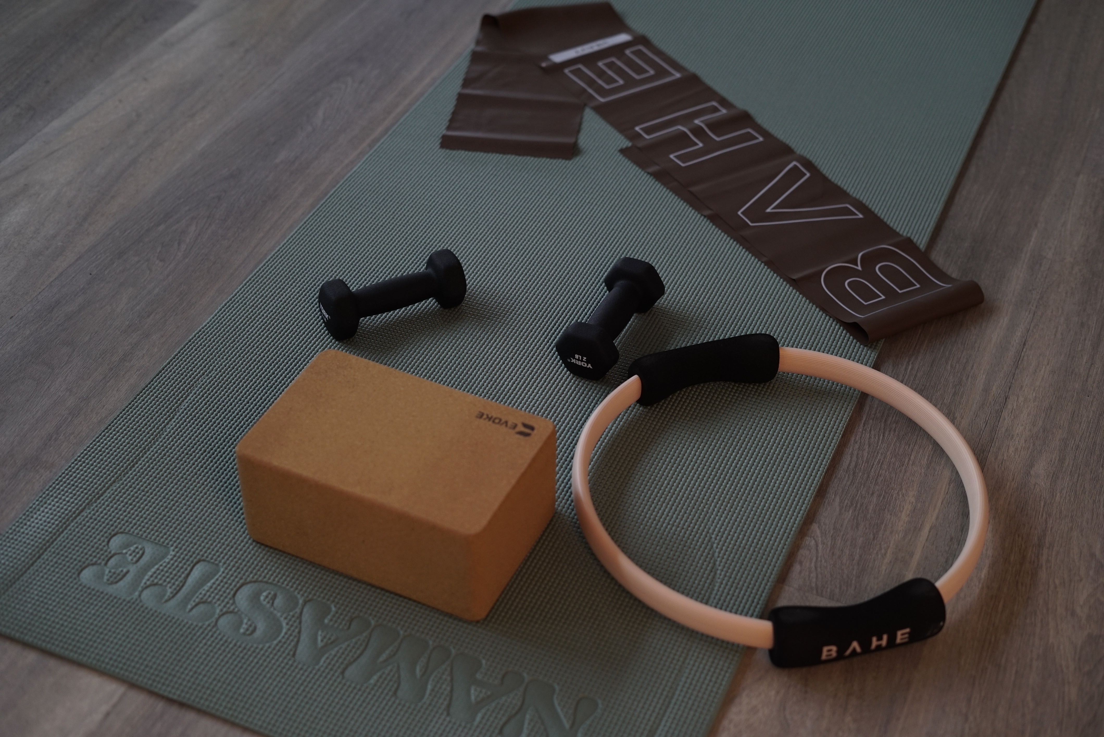 Pilates ring and props laid out on a studio mat